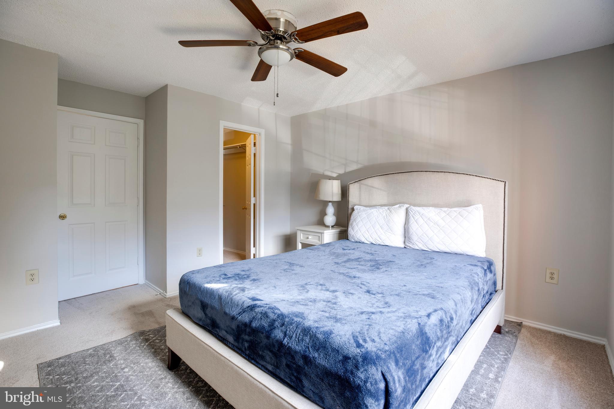 20950 Timber Ridge Terrace, Unit 202 Ashburn, VA 20147 - Photo 16 of 22 a bedroom with a bed and a window