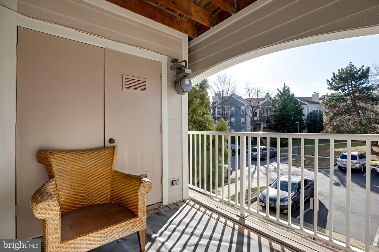 20950 Timber Ridge Terrace, Unit 202 Ashburn, VA 20147 - Photo 21 of 22 a view of a chair and table in the balcony