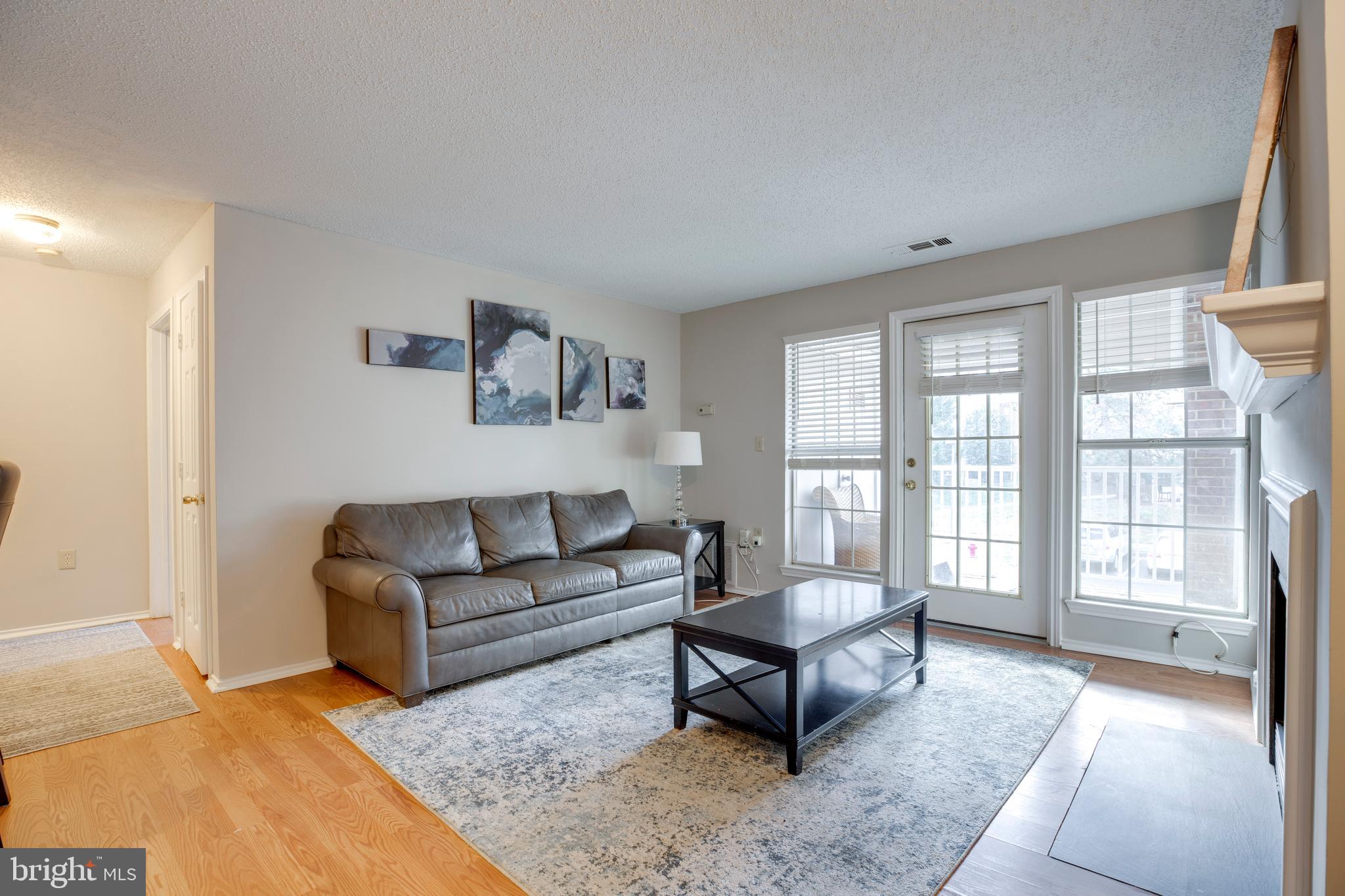 20950 Timber Ridge Terrace, Unit 202 Ashburn, VA 20147 - Photo 4 of 22 a living room with furniture and a large window