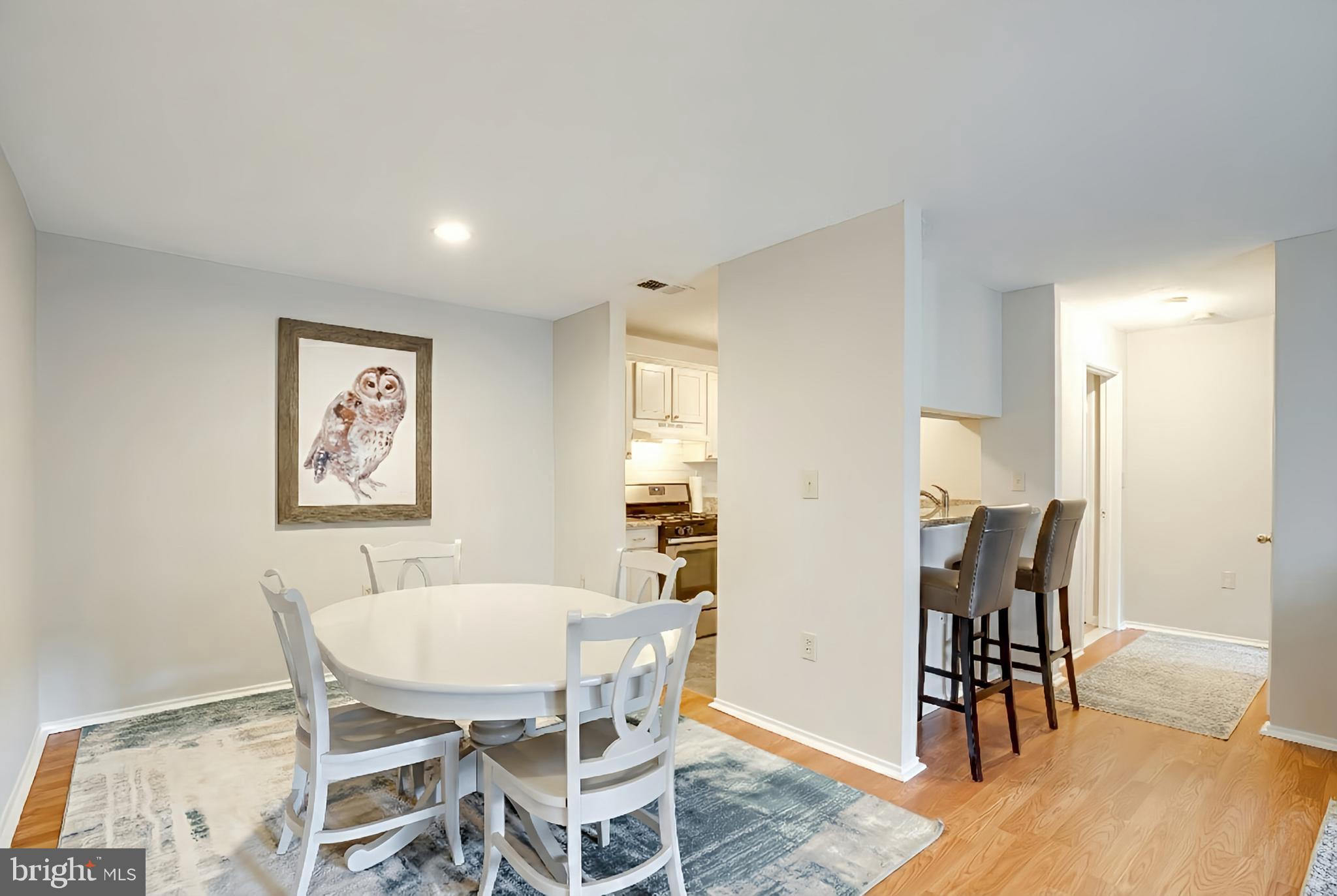 20950 Timber Ridge Terrace, Unit 202 Ashburn, VA 20147 - Photo 9 of 22 a view of a dining room with furniture and wooden floor