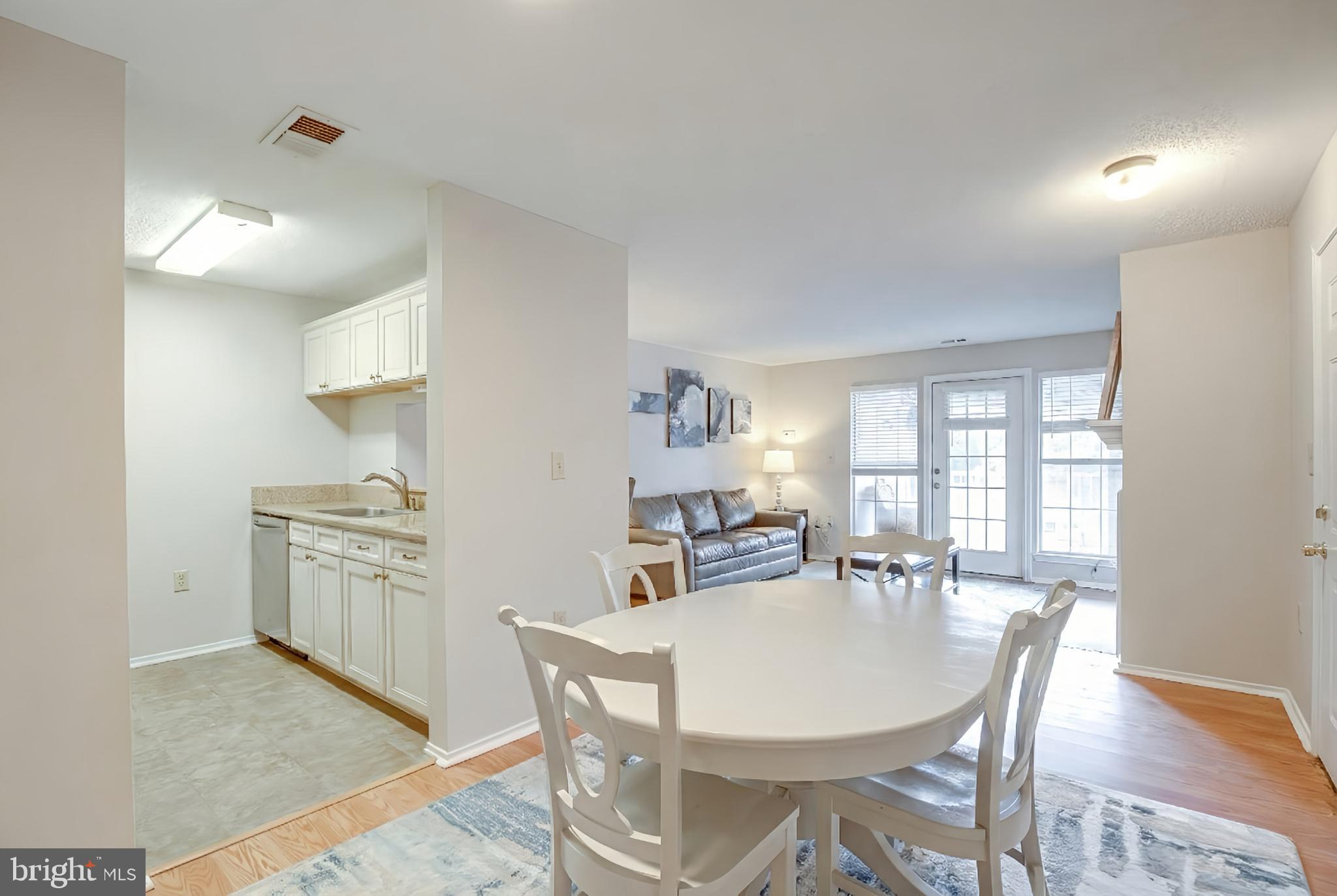 20950 Timber Ridge Terrace, Unit 202 Ashburn, VA 20147 - Photo 10 of 22 a dining room with furniture and window