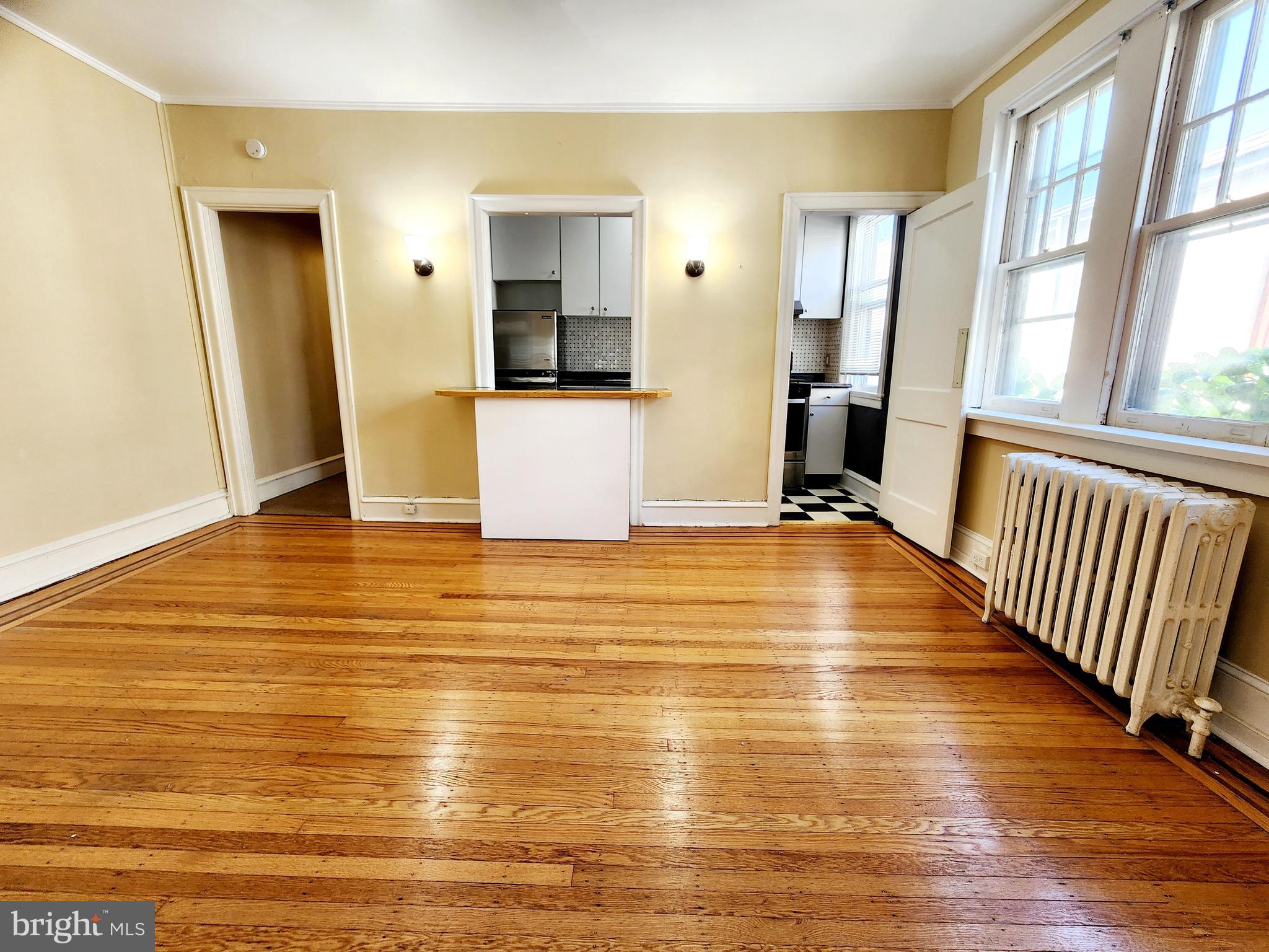 208 West Wayne Avenue Wayne, PA 19087 - Photo 2 of 9 a view of a room with wooden floor and a large window