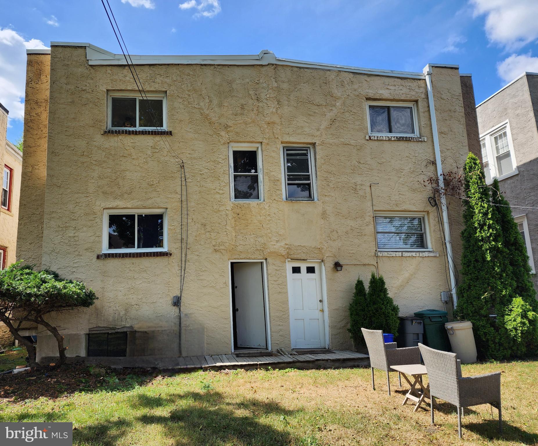 208 West Wayne Avenue Wayne, PA 19087 - Photo 9 of 9 a brick house with a yard and table and chairs