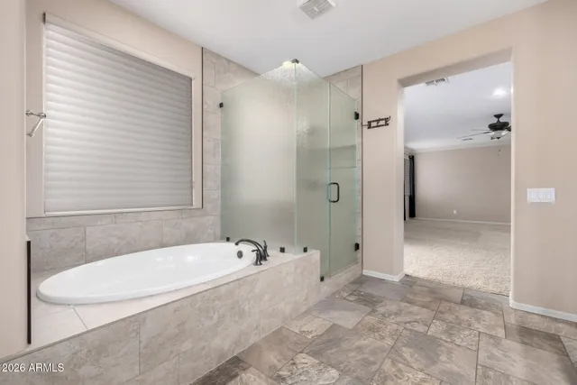 a bathroom with a tub shower and sink
