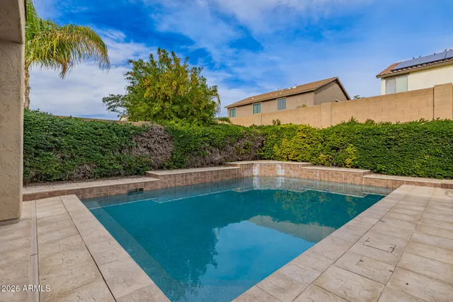 a backyard of a house with table and chairs