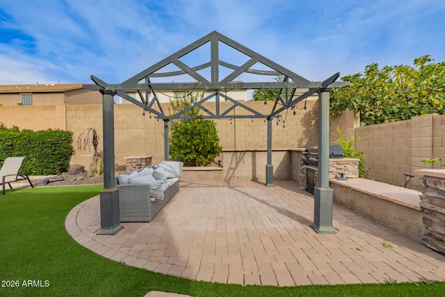 a view of a backyard with couches chair and fire pit