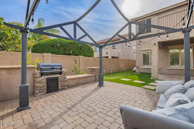 a view of yard with seating area and trees in the background