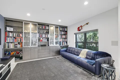 a bedroom with a bed and a night stand