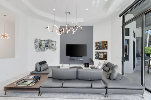 a large living room with stainless steel appliances granite countertop a couch and a refrigerator