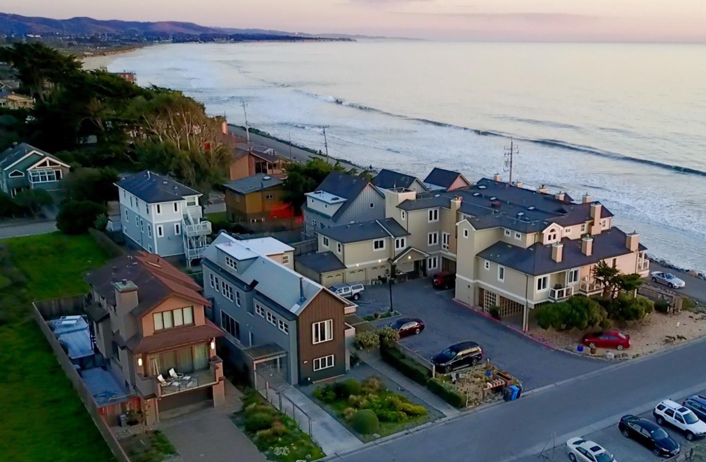 an aerial view of multiple houses with yard