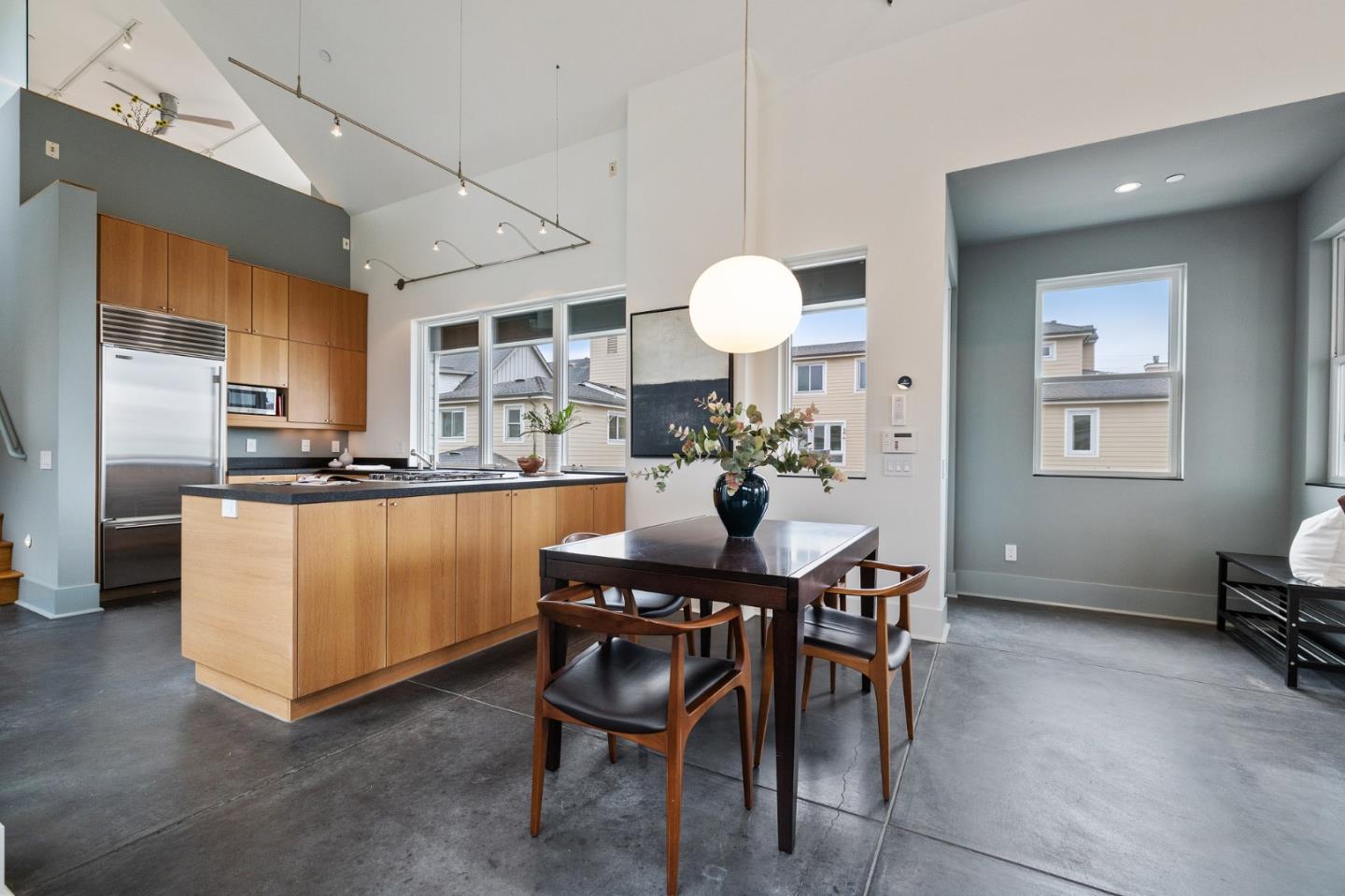 100 Coronado Avenue Half Moon Bay, CA 94019 - Photo 12 of 64 a kitchen with stainless steel appliances kitchen island granite countertop a table chairs sink and cabinets