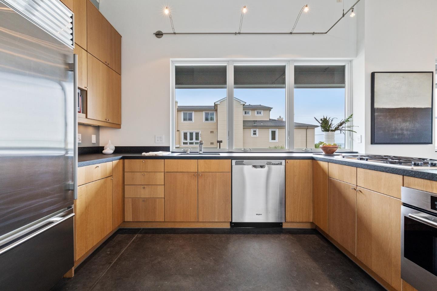 100 Coronado Avenue Half Moon Bay, CA 94019 - Photo 15 of 64 a kitchen with white cabinets and white appliances