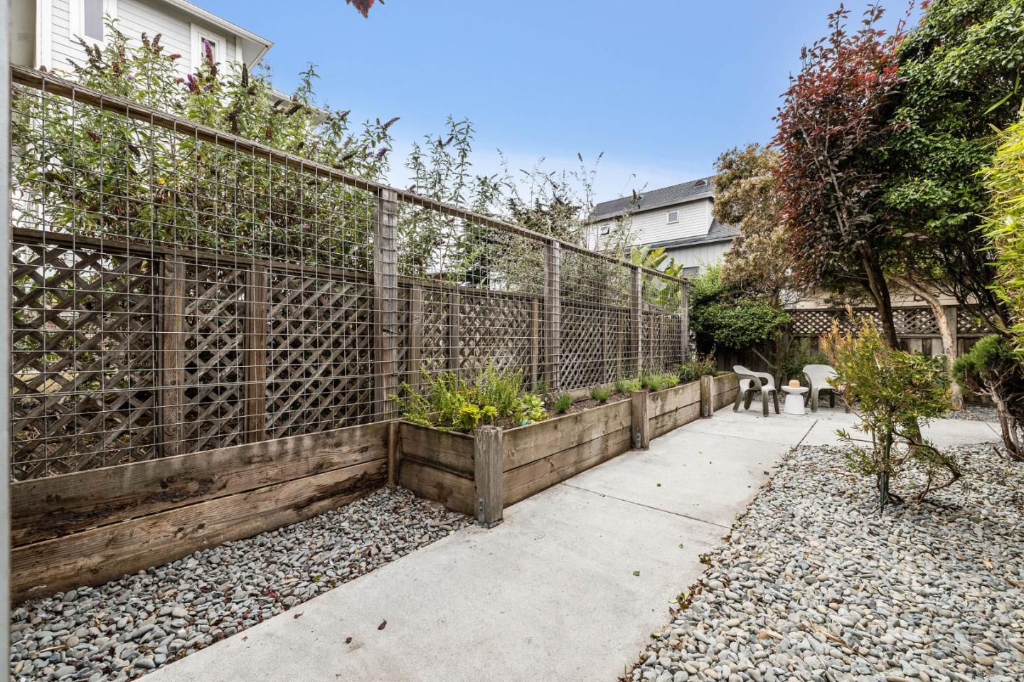 100 Coronado Avenue Half Moon Bay, CA 94019 - Photo 46 of 64 a view of a patio with couches and table with potted plants