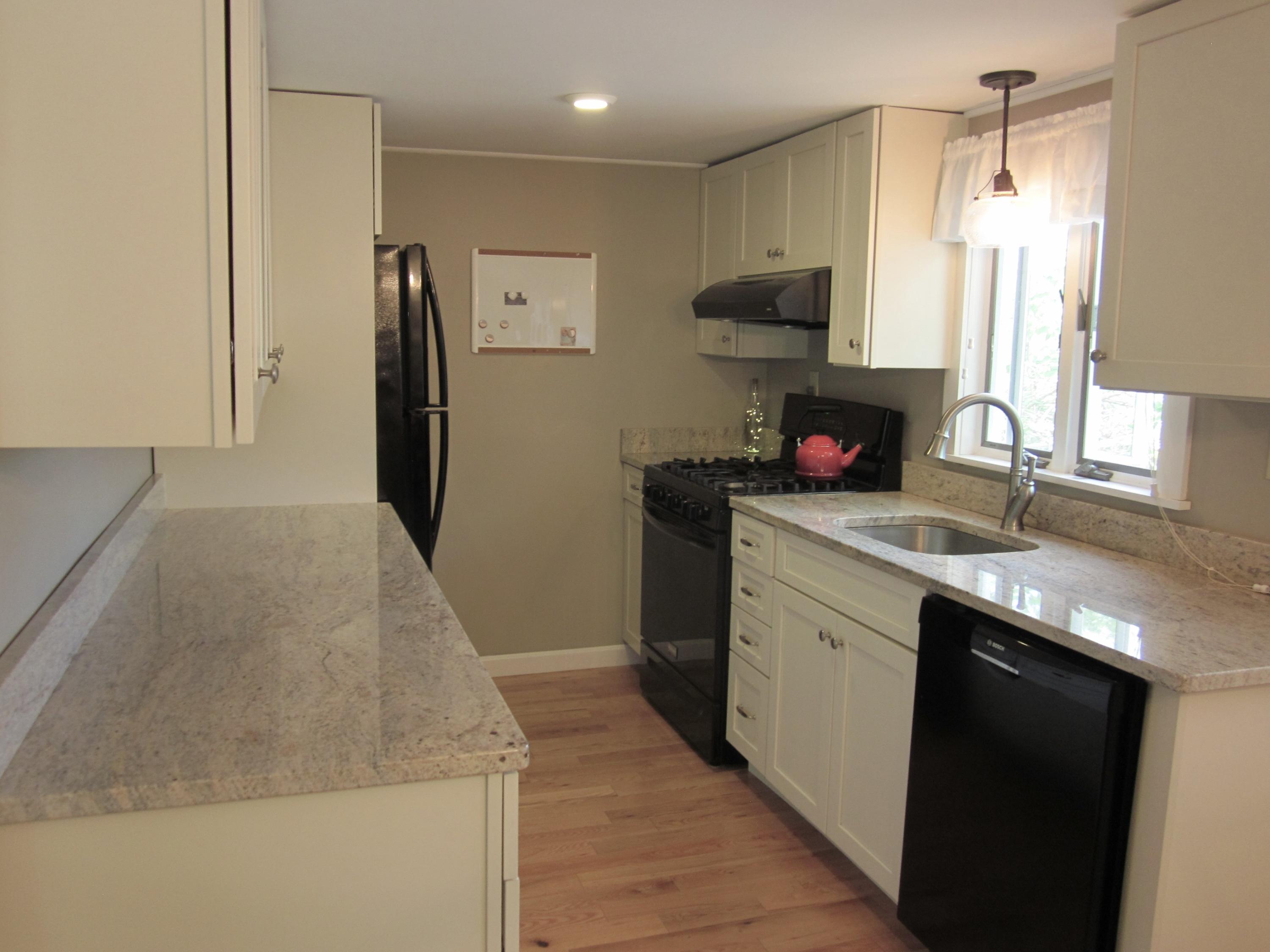 105 Sandwich Road Bourne, MA 02532 - Photo 15 of 19 a kitchen with stainless steel appliances granite countertop a sink and a stove top oven
