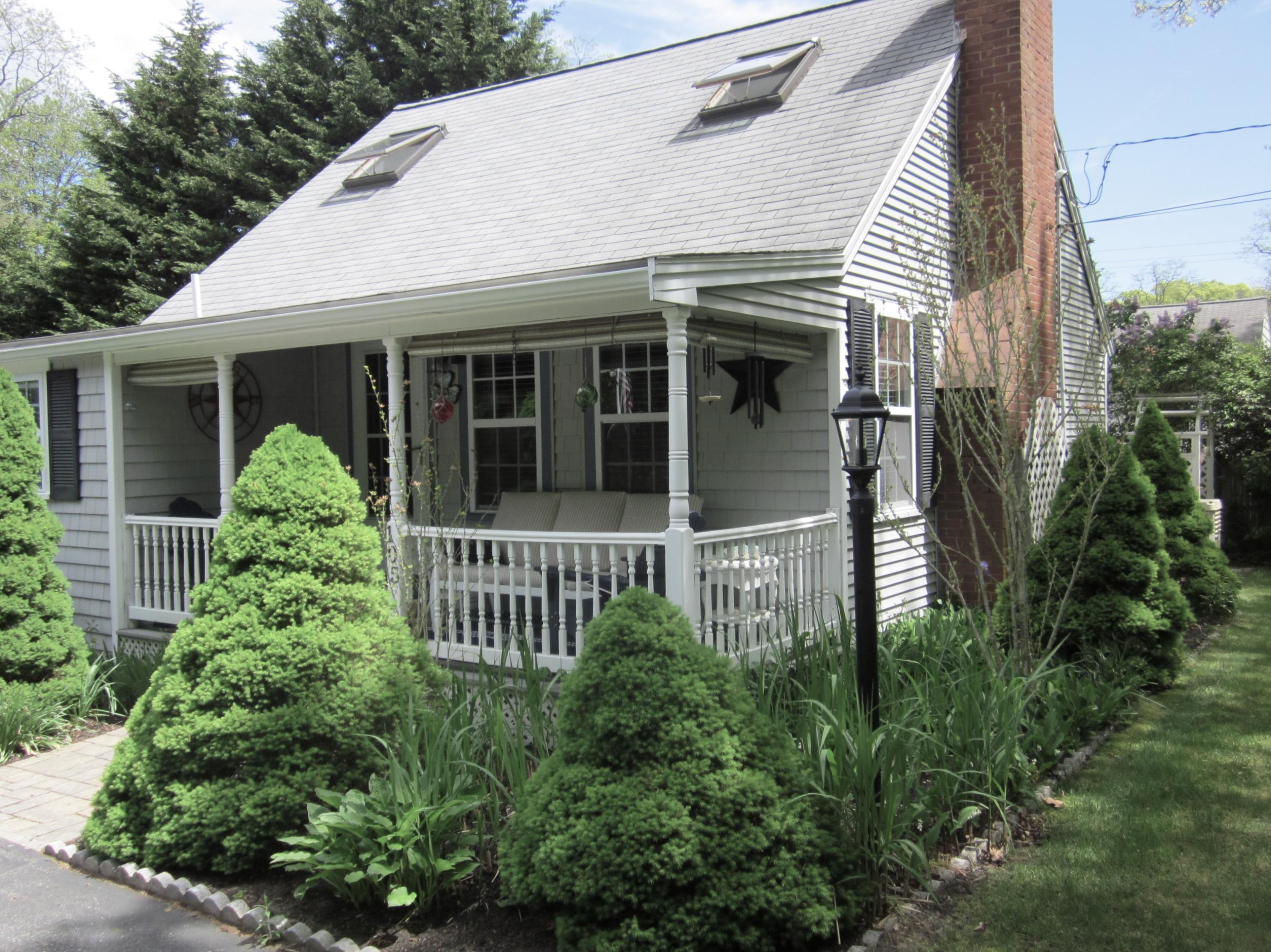 105 Sandwich Road Bourne, MA 02532 - Photo 2 of 19 a view of a house with brick walls and potted plants