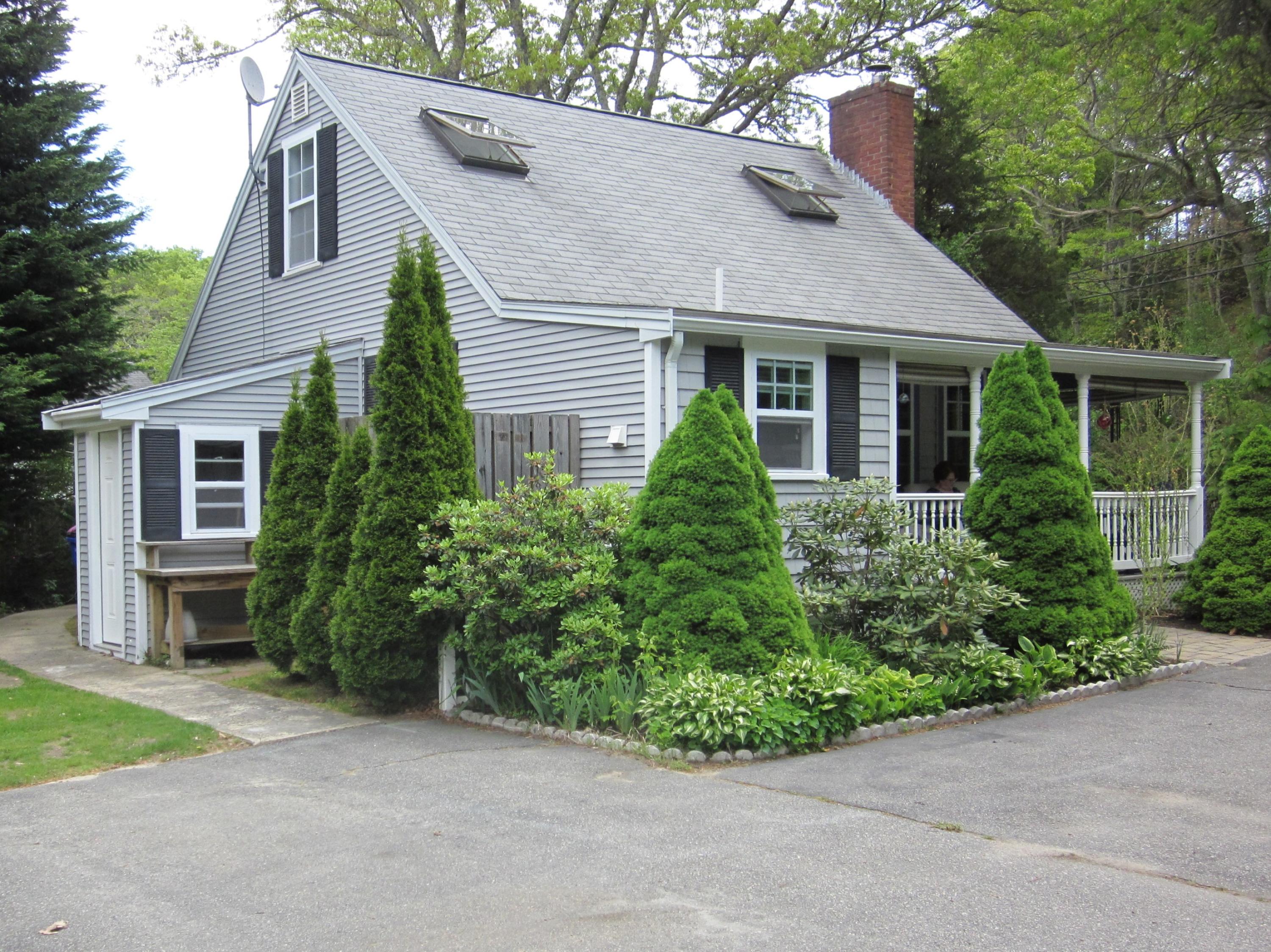 105 Sandwich Road Bourne, MA 02532 - Photo 3 of 19 front view of a house with a garden