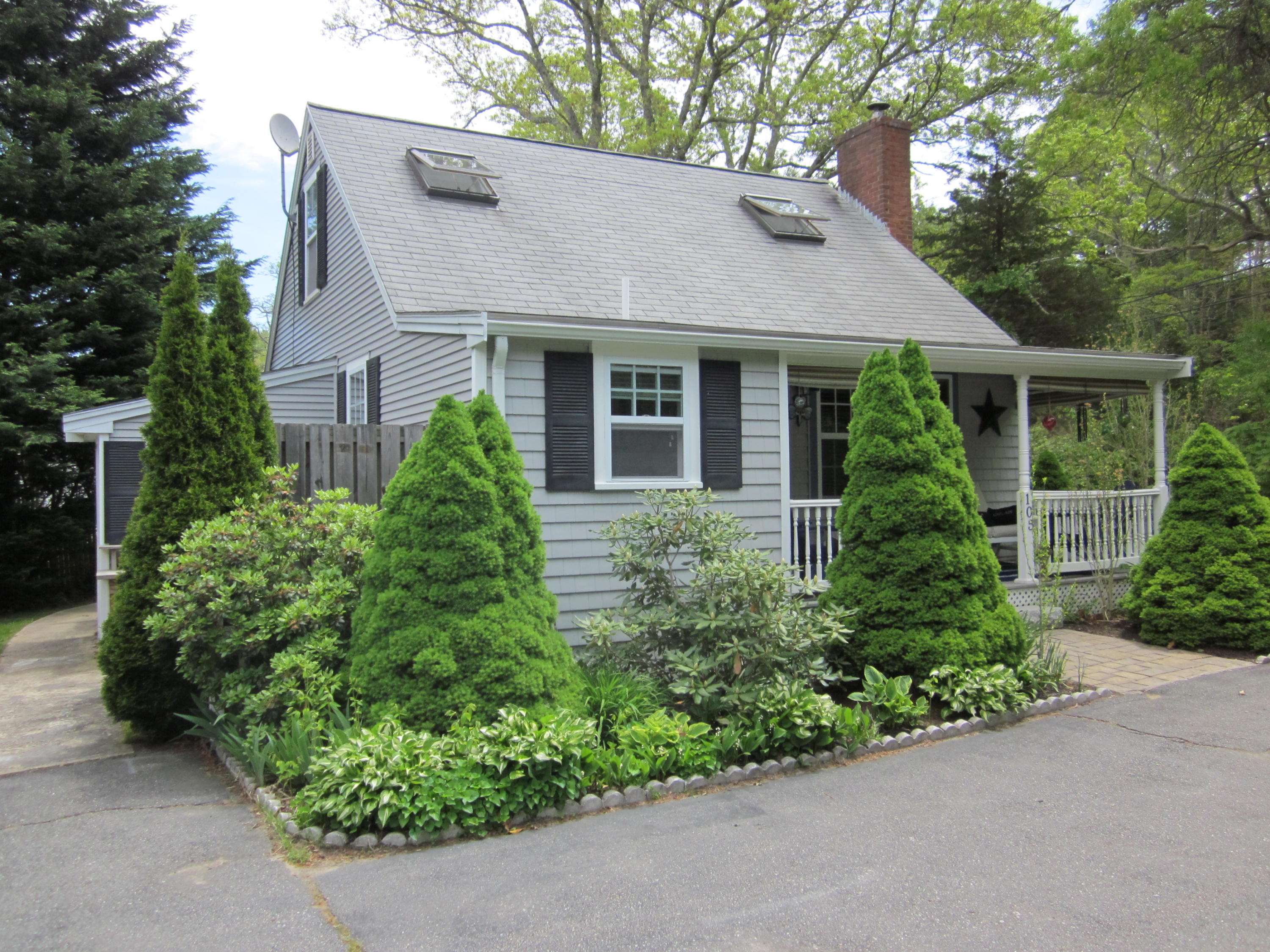 105 Sandwich Road Bourne, MA 02532 - Photo 5 of 19 front view of a house with a yard