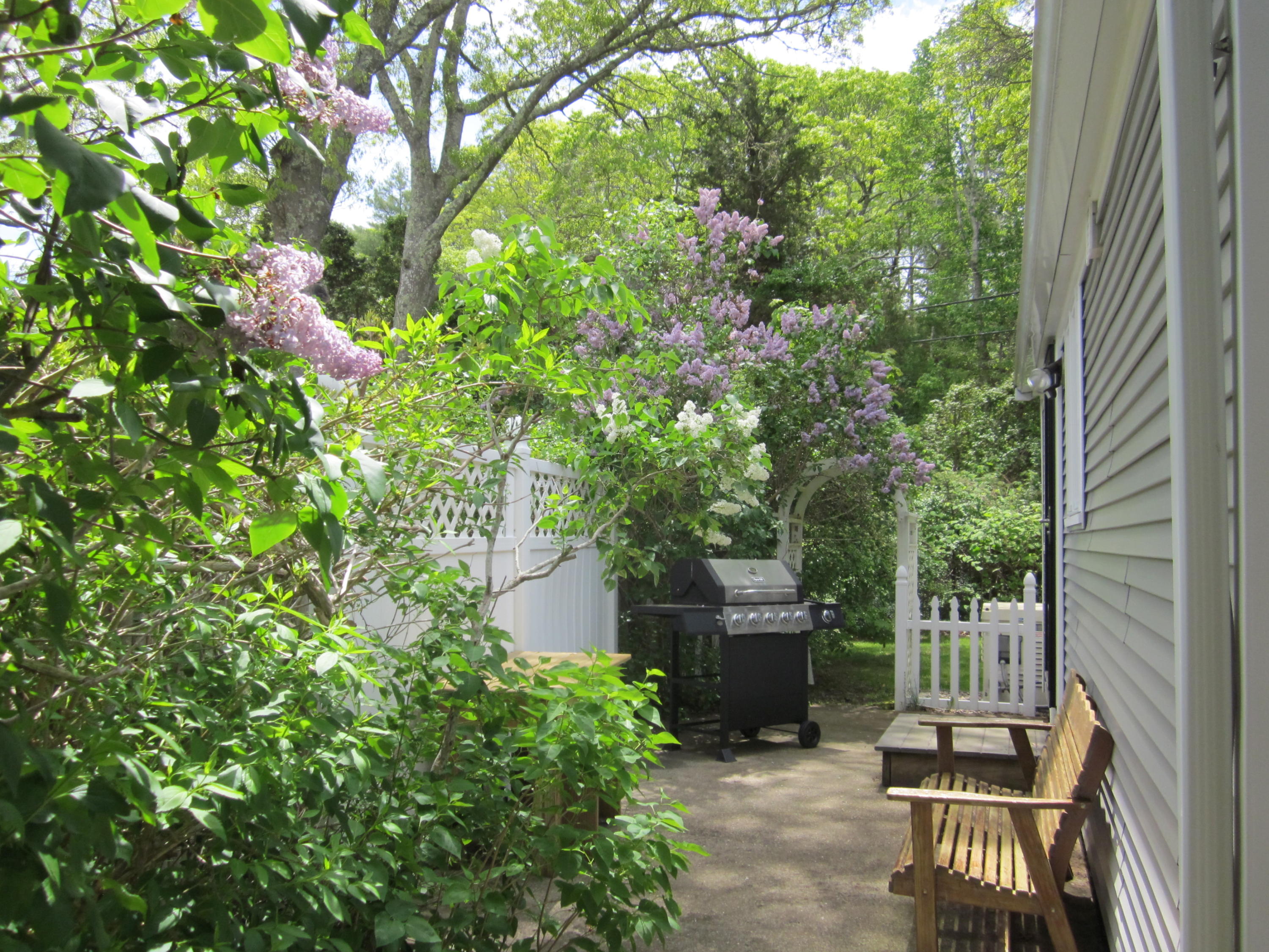 105 Sandwich Road Bourne, MA 02532 - Photo 7 of 19 a view of a patio with table and chairs and potted plants