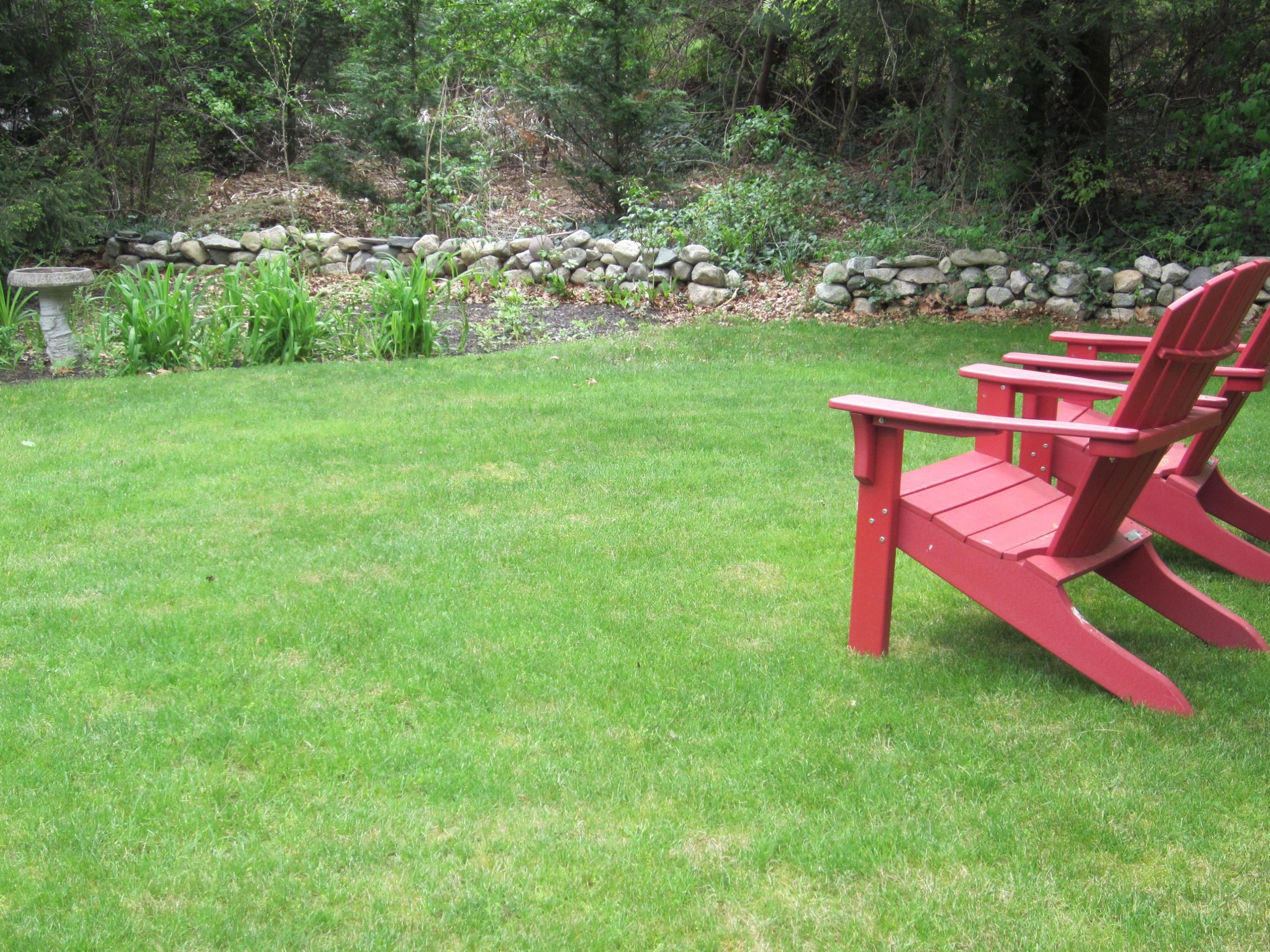 105 Sandwich Road Bourne, MA 02532 - Photo 9 of 19 a wooden bench sitting in the middle of a park
