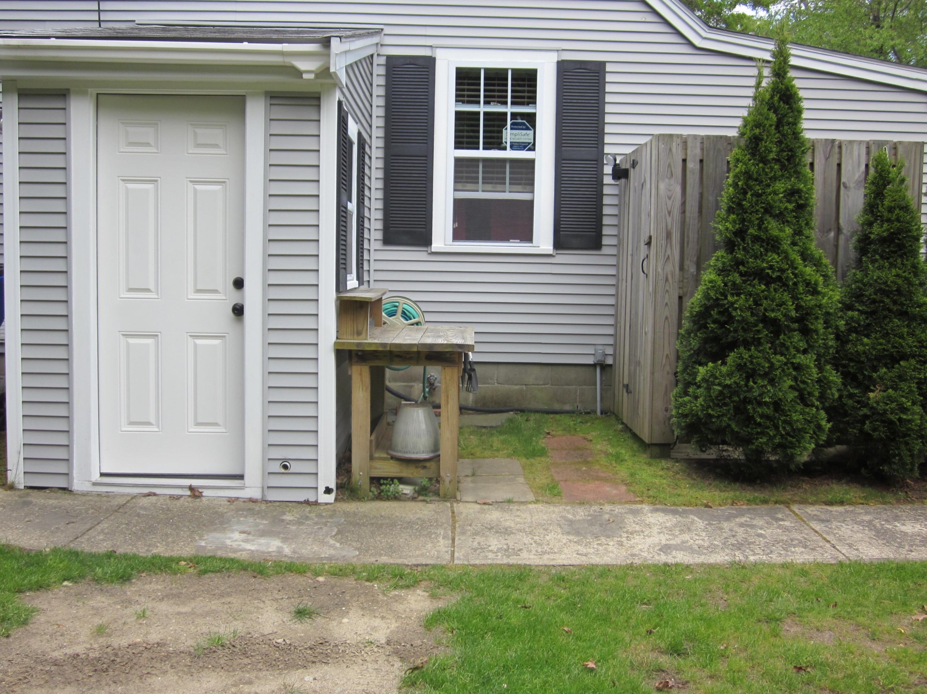 105 Sandwich Road Bourne, MA 02532 - Photo 10 of 19 a view of a house with a yard