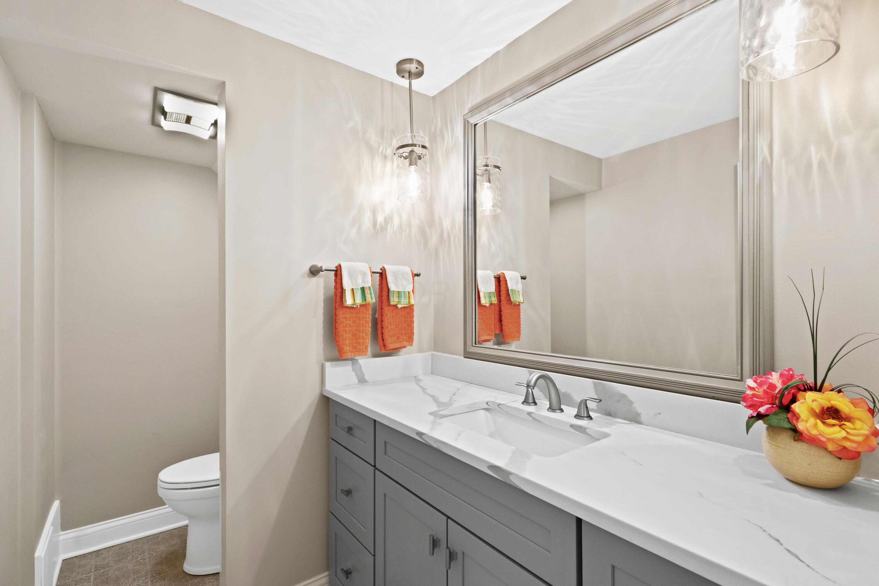 1560 Carriage Road Powell, OH 43065 - Photo 49 of 73 Vanity with gray cabinetry, integrated rectangular sink, and light-toned quartz countertop