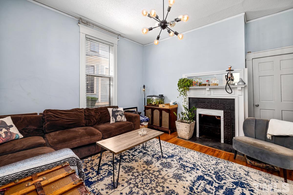 415 New Bern Avenue Raleigh, NC 27601 - Photo 15 of 54 a living room with furniture a fireplace and a window