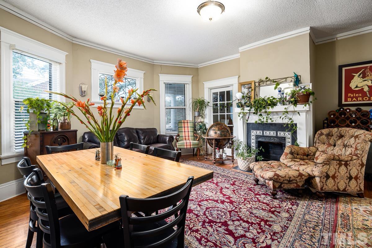 415 New Bern Avenue Raleigh, NC 27601 - Photo 19 of 54 a living room with furniture a fireplace and a large window