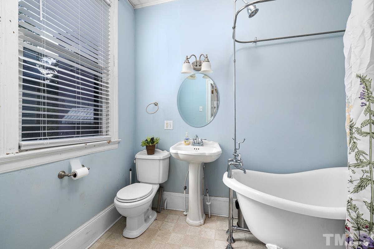 415 New Bern Avenue Raleigh, NC 27601 - Photo 23 of 54 a bathroom with a toilet a sink and a bathtub