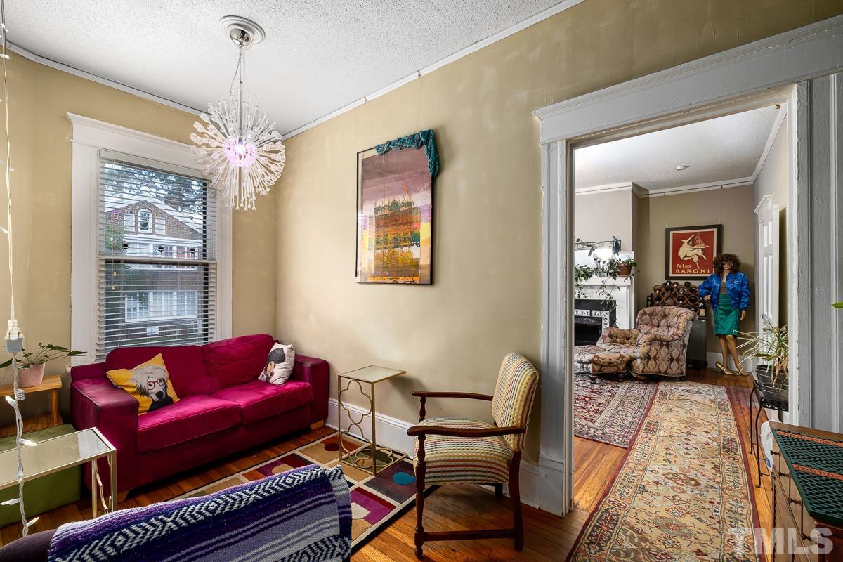 415 New Bern Avenue Raleigh, NC 27601 - Photo 26 of 54 a living room with furniture chandelier and a rug