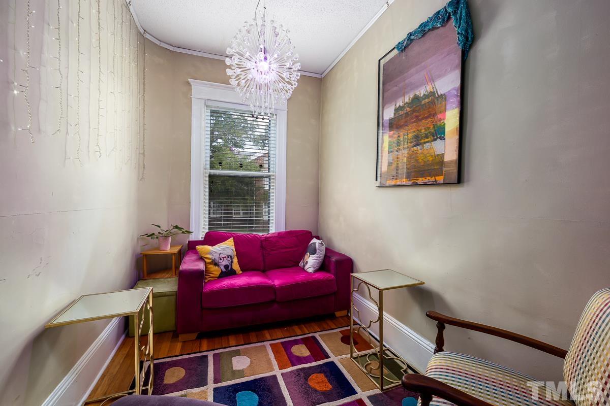 415 New Bern Avenue Raleigh, NC 27601 - Photo 27 of 54 a living room with furniture and a chandelier