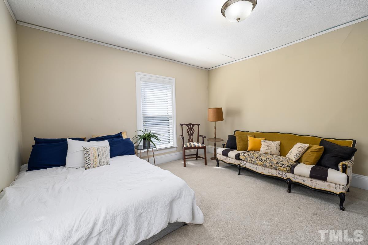 415 New Bern Avenue Raleigh, NC 27601 - Photo 31 of 54 a bedroom with a bed couch and window