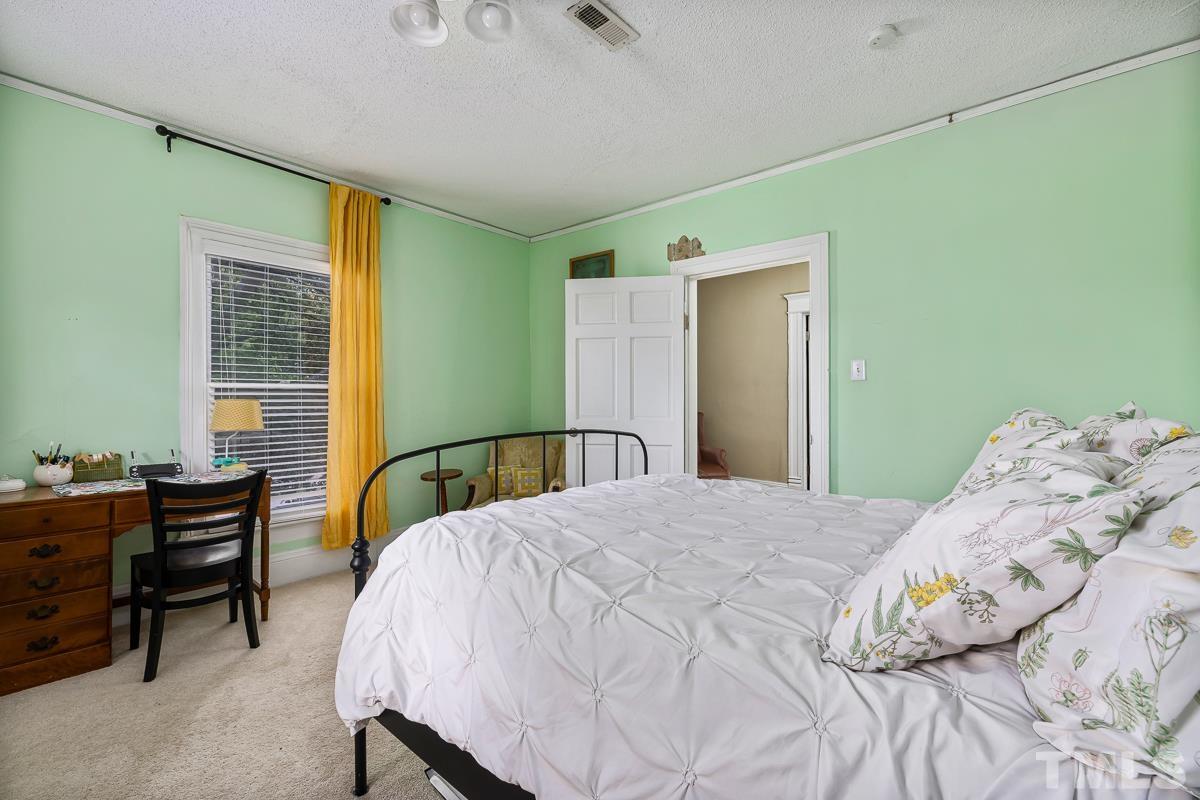 415 New Bern Avenue Raleigh, NC 27601 - Photo 34 of 54 a bedroom with a bed and furniture