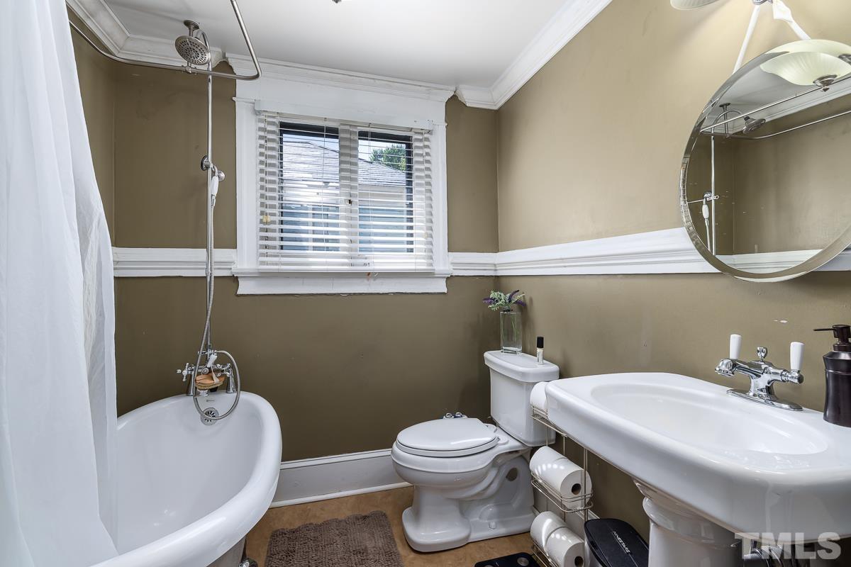 415 New Bern Avenue Raleigh, NC 27601 - Photo 35 of 54 a bathroom with a sink a toilet and a mirror