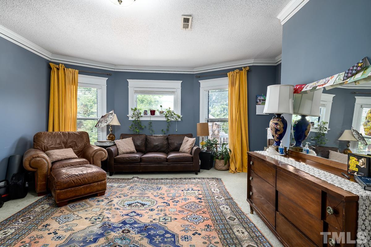 415 New Bern Avenue Raleigh, NC 27601 - Photo 36 of 54 a living room with furniture and a flat screen tv