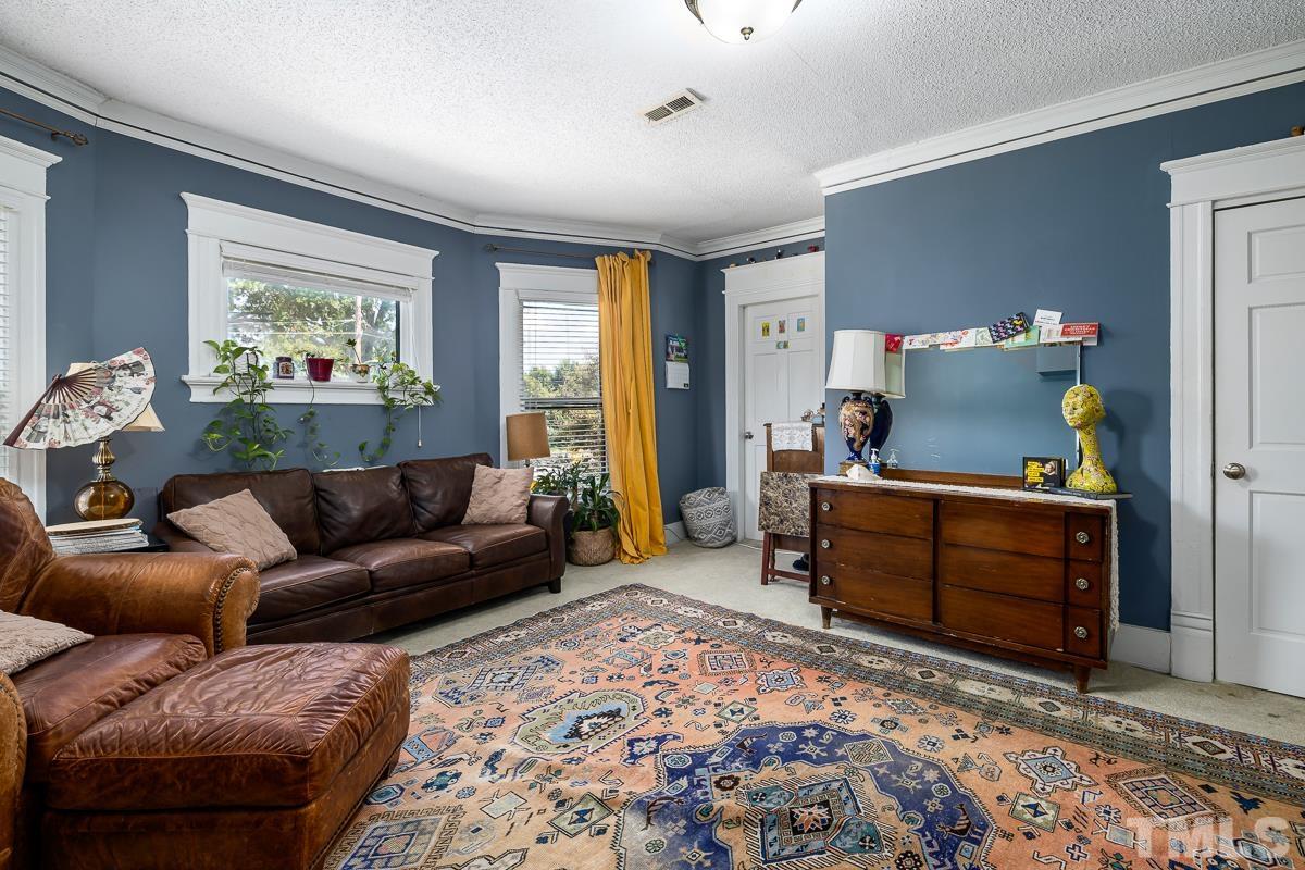 415 New Bern Avenue Raleigh, NC 27601 - Photo 37 of 54 a living room with furniture and a window