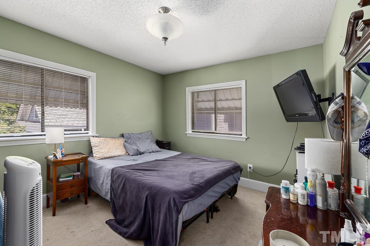 415 New Bern Avenue Raleigh, NC 27601 - Photo 47 of 54 a bedroom with a bed wooden floor and window