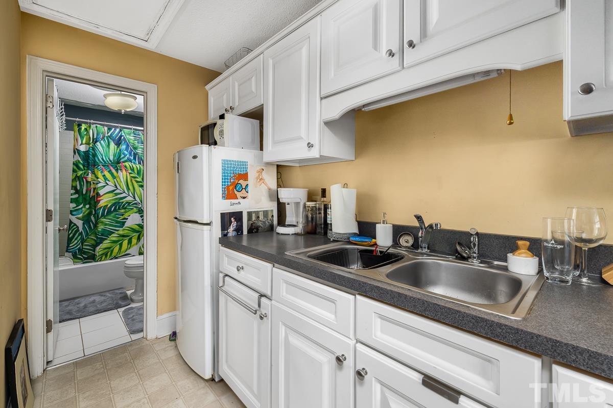 415 New Bern Avenue Raleigh, NC 27601 - Photo 50 of 54 a kitchen with stainless steel appliances granite countertop a sink and cabinets
