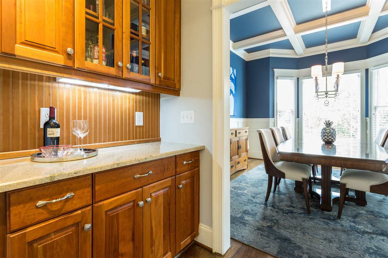 A butler's pantry is conveniently located between the dining room and kitchen and offers granite counters, glass cabinet doors, and under-cabinet lighting. Butler's Pantry
