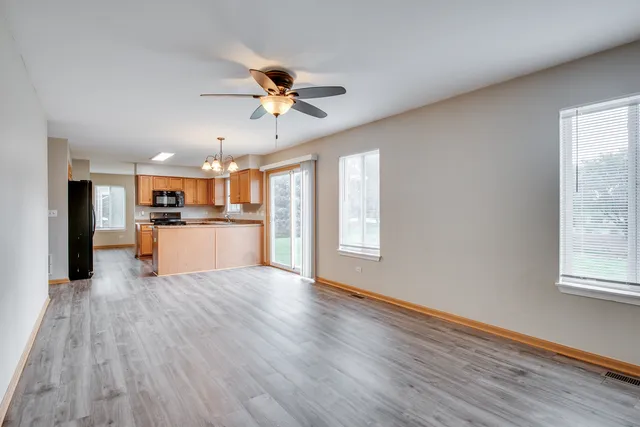 a view of a kitchen with a microwave and wooden floor