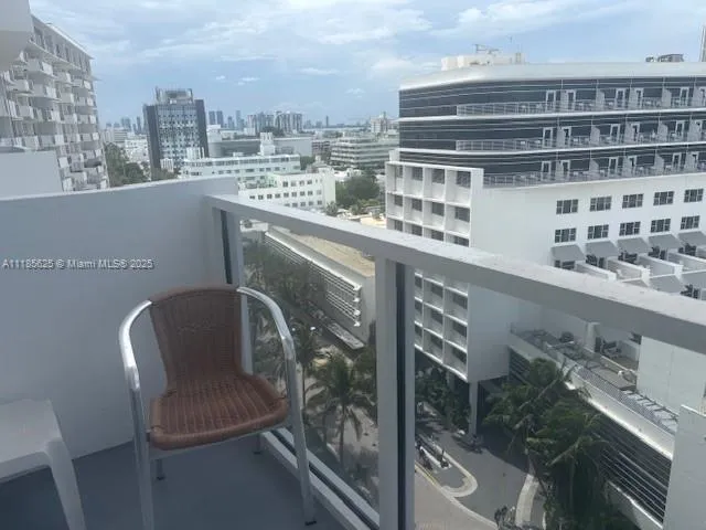 a balcony with a bench and city view