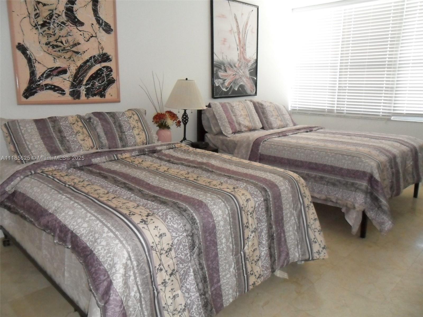 100 Lincoln Road, Unit 1243 Miami Beach, FL 33139 - Photo 6 of 29 a bedroom with two beds and a couch