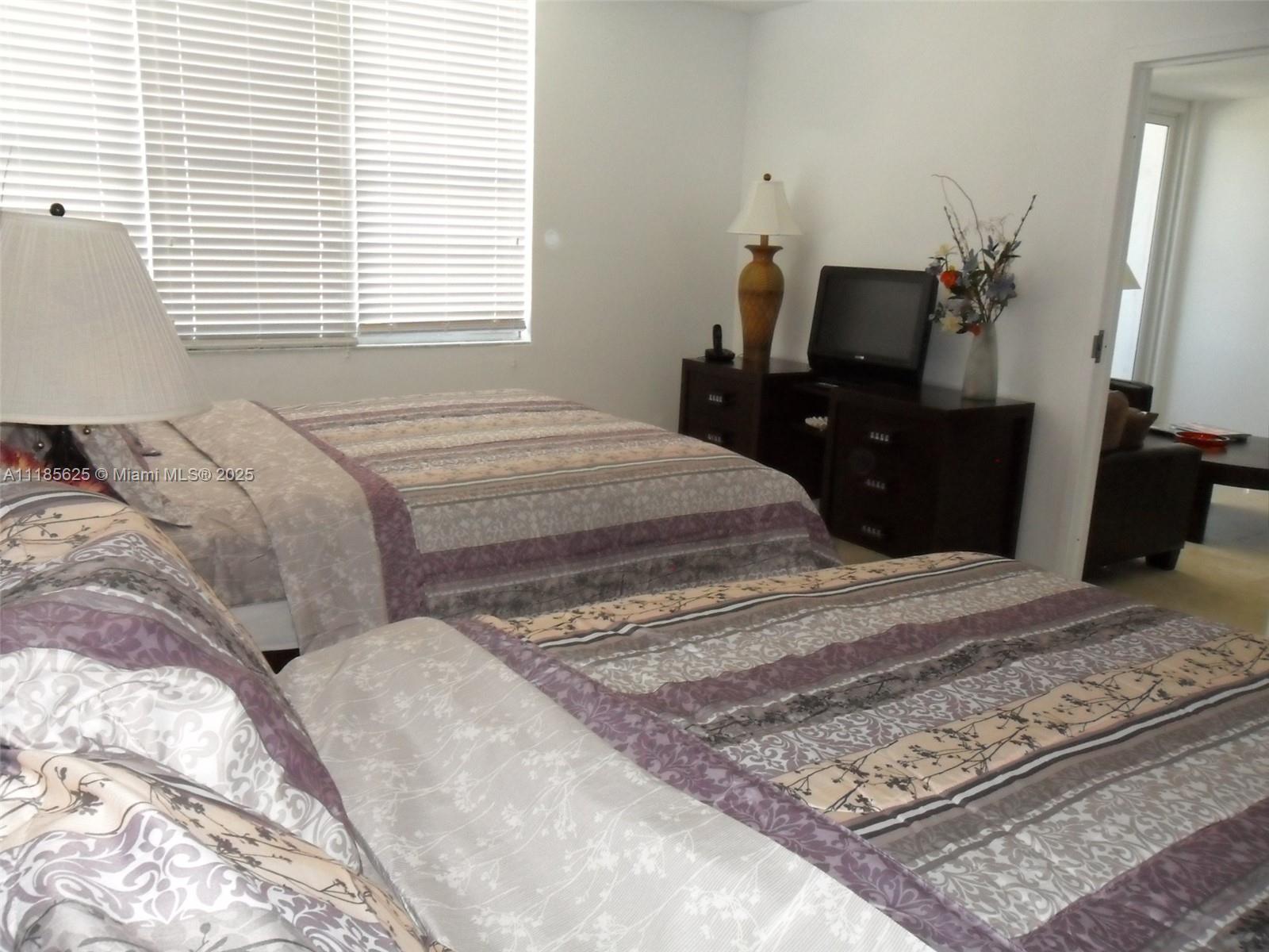 100 Lincoln Road, Unit 1243 Miami Beach, FL 33139 - Photo 7 of 29 a bedroom with a bed and wooden floor