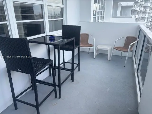 a balcony with table and chairs