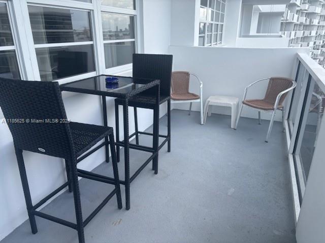 100 Lincoln Road, Unit 1243 Miami Beach, FL 33139 - Photo 10 of 29 a balcony with table and chairs