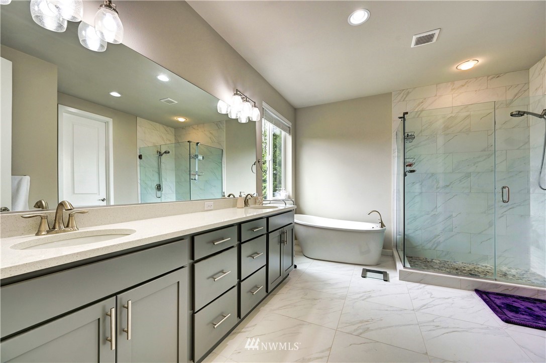 3406 216th Place Southeast Bothell, WA 98021 - Photo 14 of 30 a spacious bathroom with a double vanity sink mirror and toilet