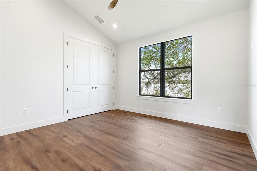 1615 Cole Road Orlando, FL 32803 - Photo 25 of 31 an empty room with wooden floor and windows