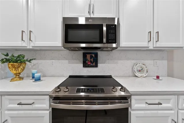 a kitchen with a stove and a microwave