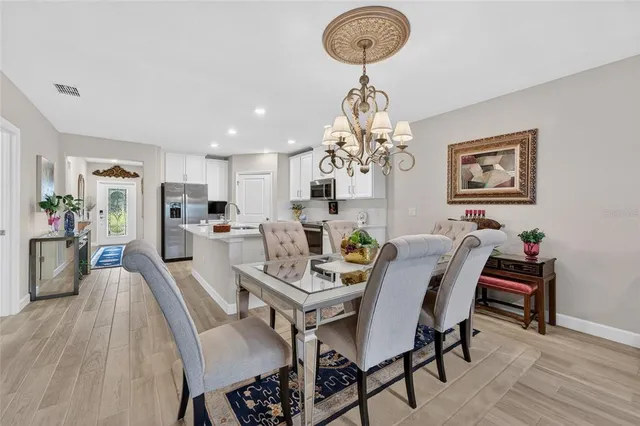 a view of a dining room with furniture and chandelier