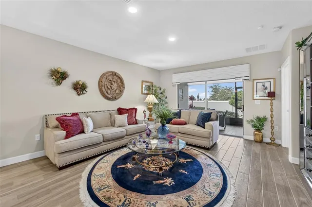 a living room with furniture a couch and a large window