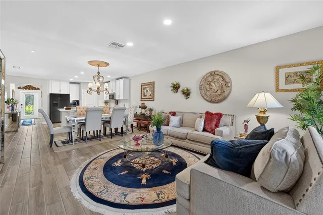a living room with furniture a clock and a table